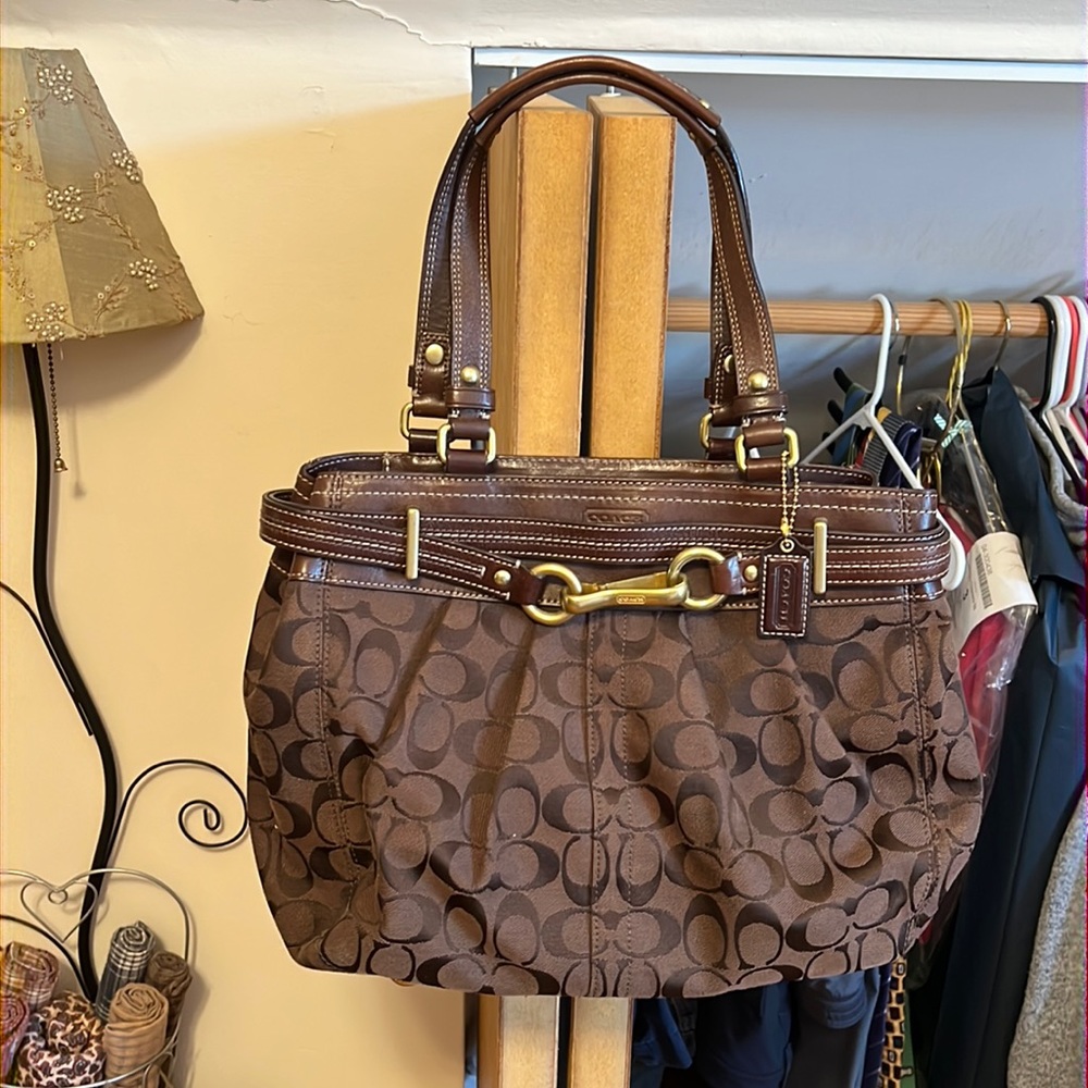 Brown Coach purse with short handles.